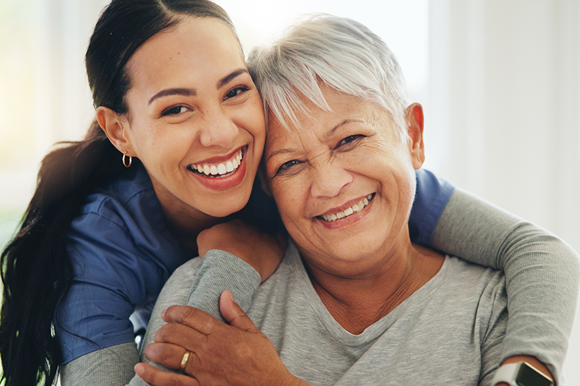 happy-woman-nurse-hug-senior-patient