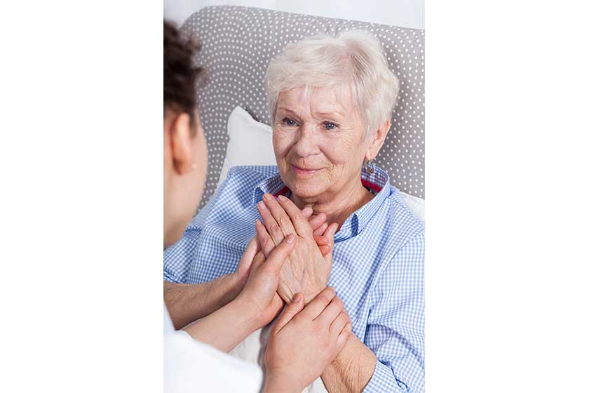 Nurse comforting elderly woman